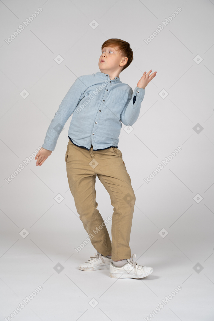 A young boy freezing up in a weird pose
