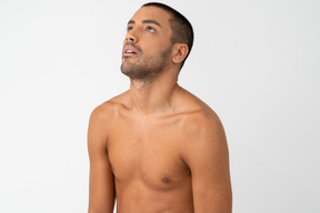 Barechested young male with 'sick of' facial expression