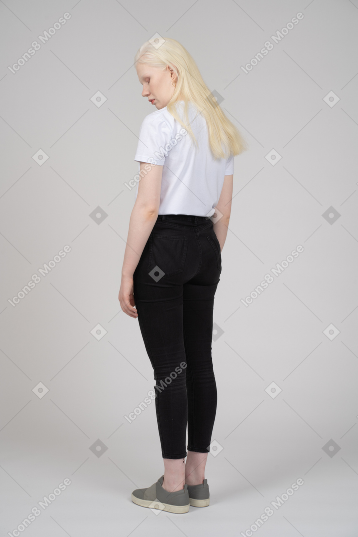 Three-quarter back view of a girl in casual clothes