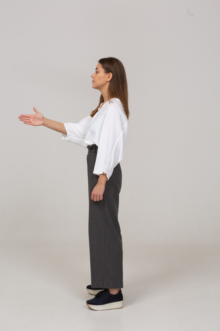 Side view of a young lady in office clothing showing the right direction