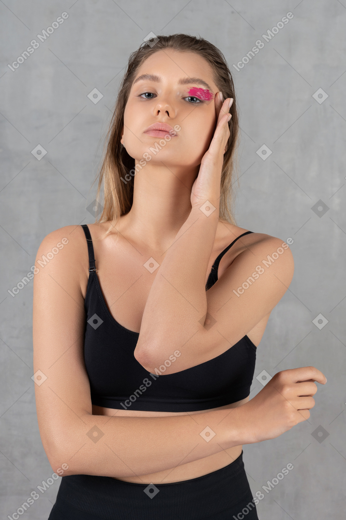 Attractive young woman showing off her bright pink eye make-up