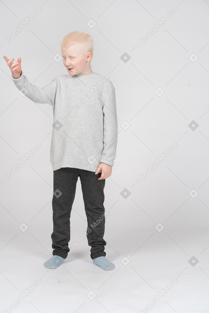 Little boy saying something and gesturing with one hand