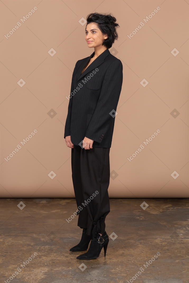 Three-quarter view of a pleased businesswoman looking aside