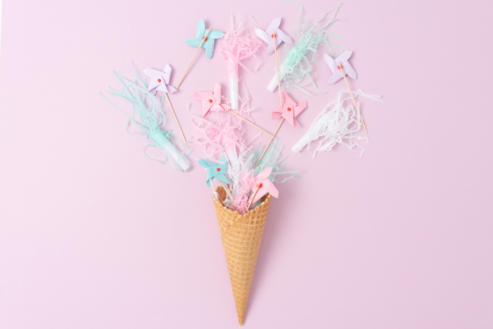 Pastel pinwheels and party horns in an ice cream cone