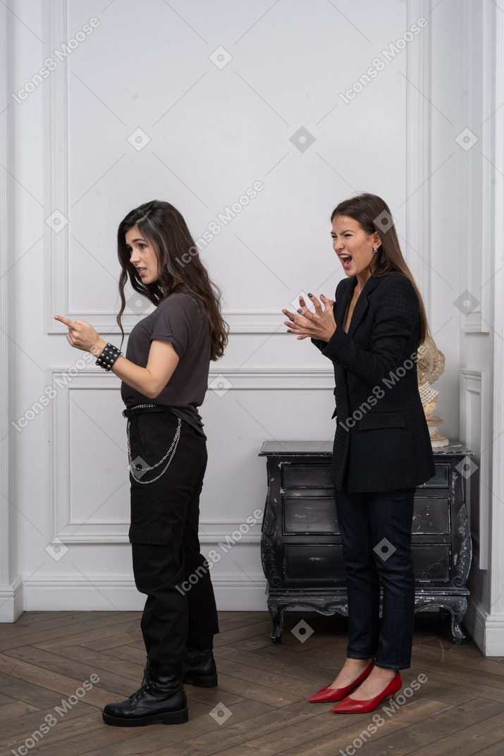 Two women scolding someone