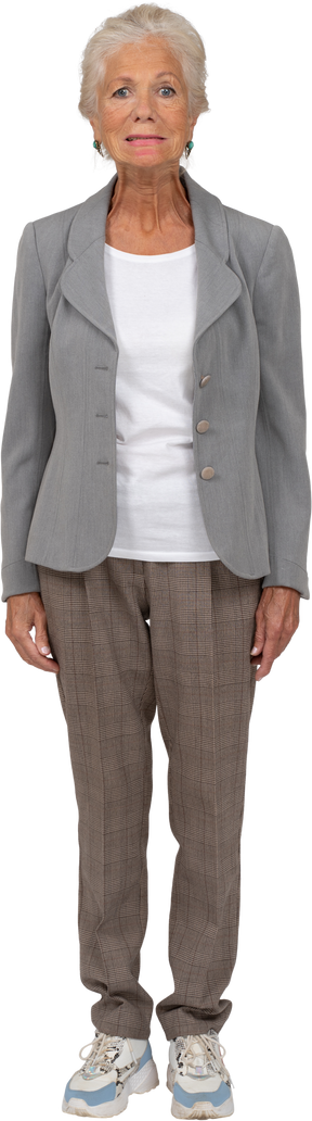 Front view of an old lady in suit looking at camera and making faces