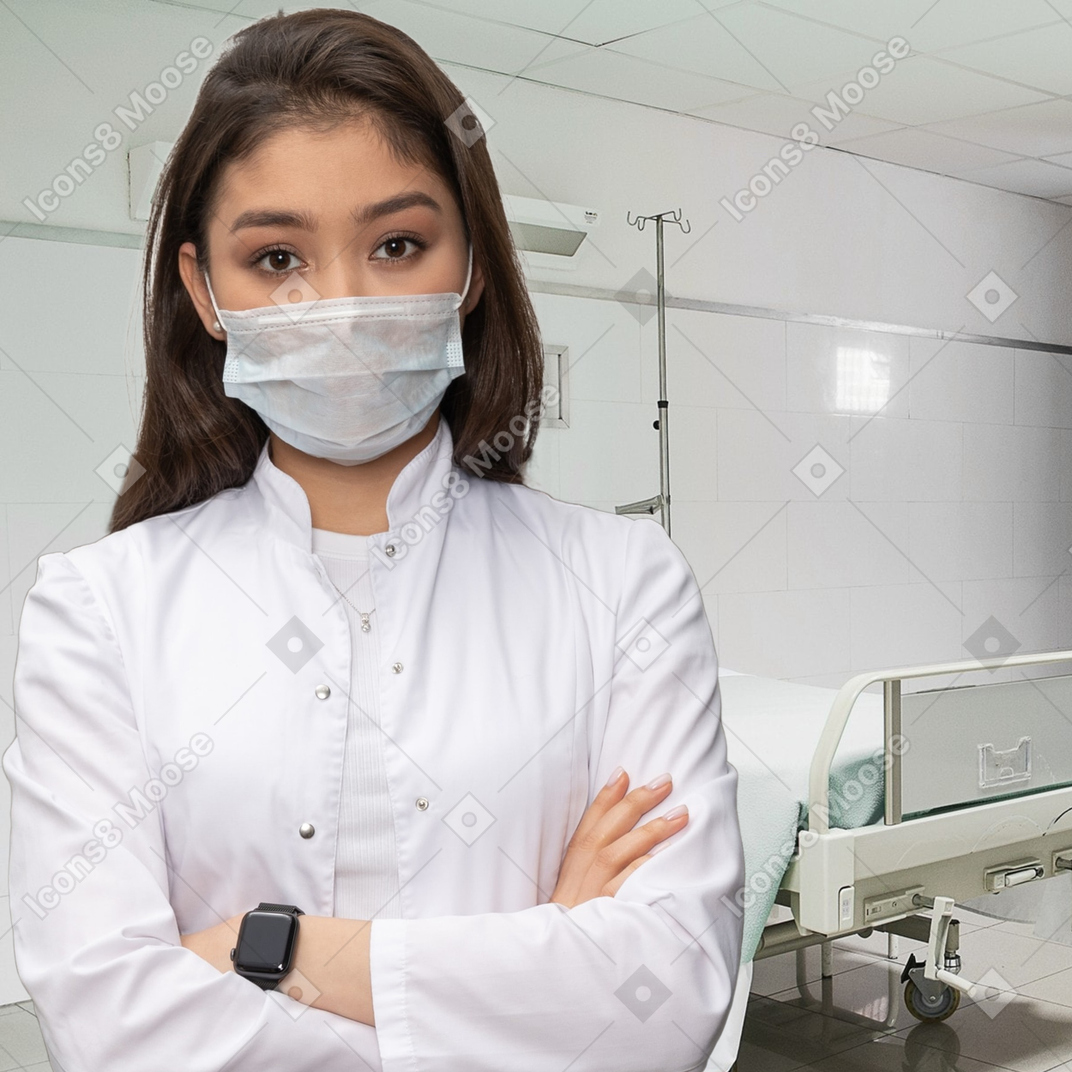 A woman wearing a face mask in a hospital