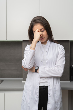 Front view of a tired female hiding face