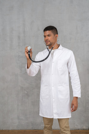 Male doctor using a stethoscope