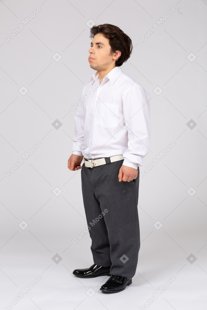 Three-quarter view of a young man in business casual clothes looking up