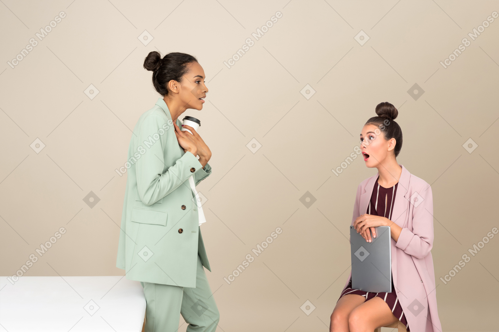 Amazed young woman looking at her female colleague