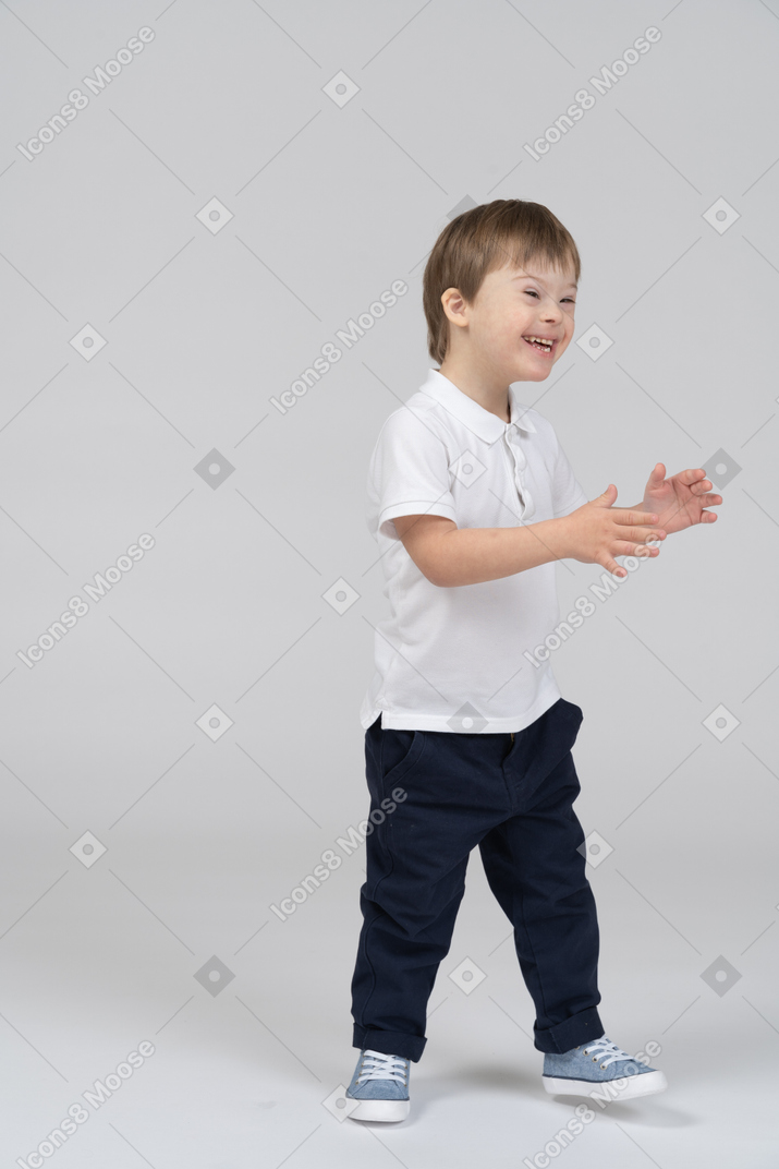 Smiling little boy clapping his hands
