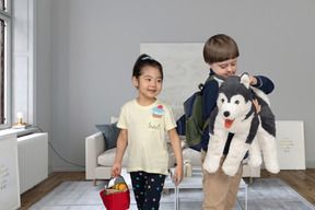 A girl and a boy holding a soft toy
