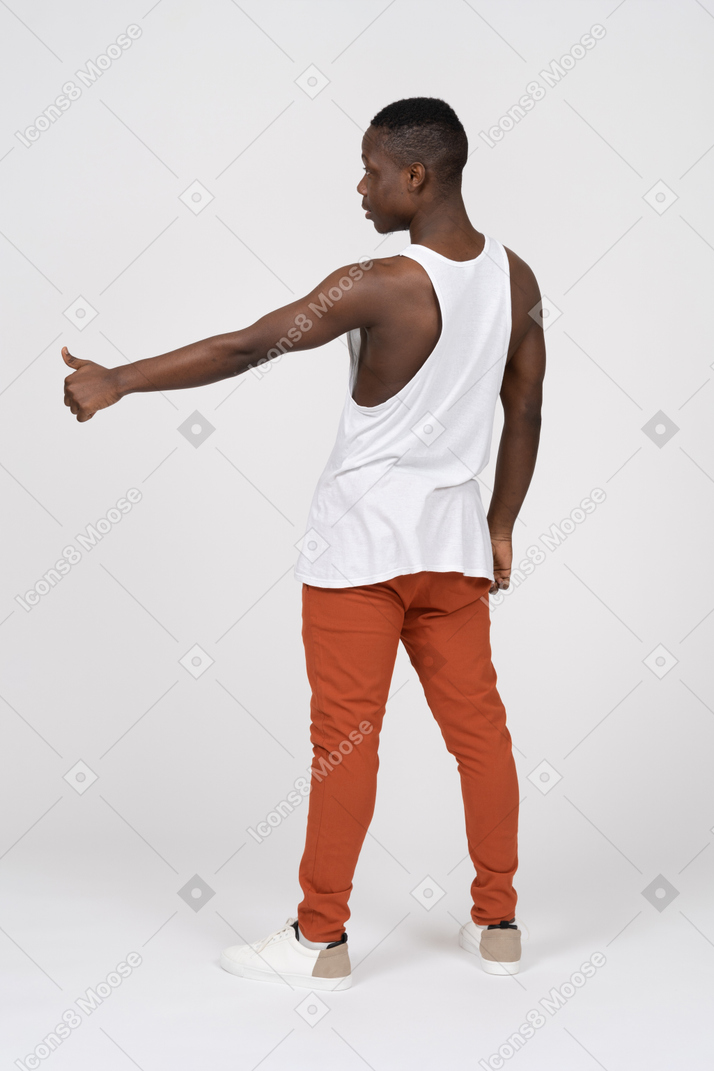 Muscular young man showing thumbs up