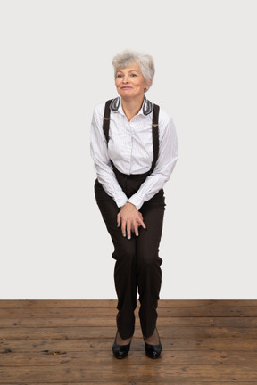 Awkward businesswoman standing with legs pressed together