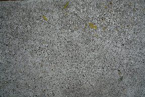 A black and white photo of a concrete wall with a yellow line