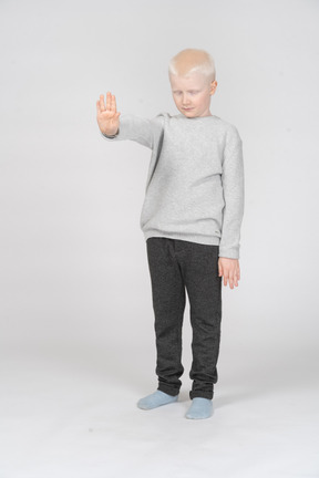 Little boy with closed eyes and outstretched hand