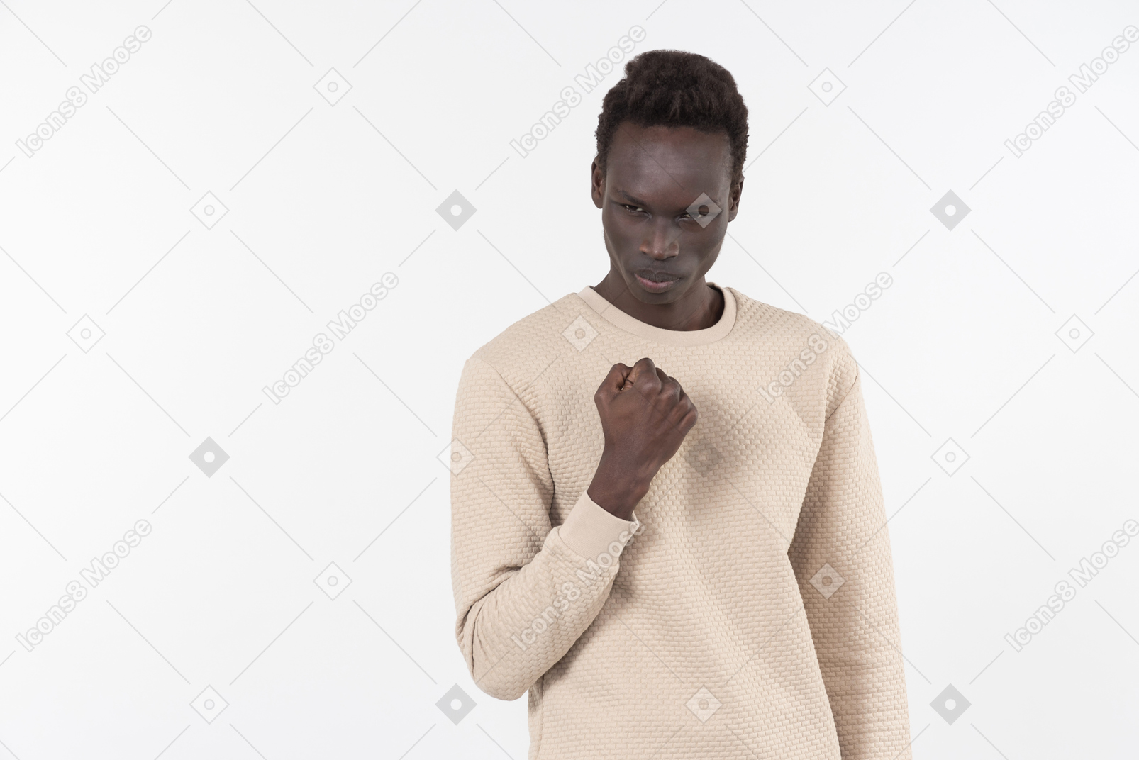 A young black man in a grey sweater standing alone on the white background