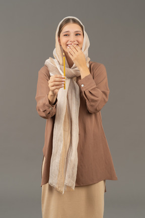 Young religious woman holding a candle and laughing