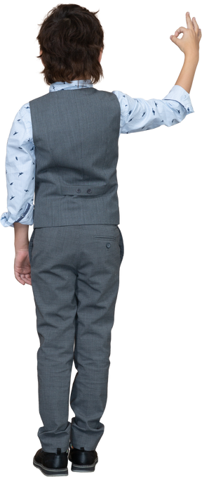 Rear view of a boy in grey suit showing ok sign