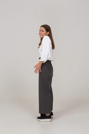 Three-quarter view of a smiling young lady in office clothing outspreading fingers