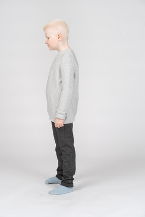 Side view of a little boy standing still