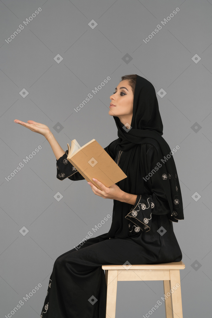 Muslim teacher explaining a book