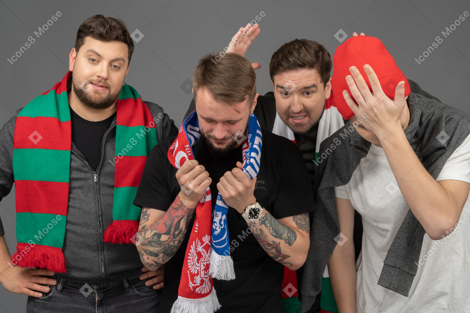 Close-up of four upset male football fans