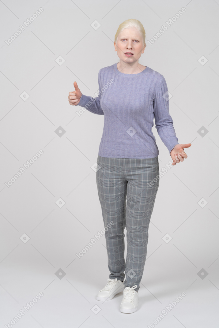 Serious young woman threatening with hand