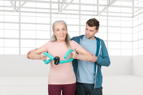 Elderly woman exercising with a trainer