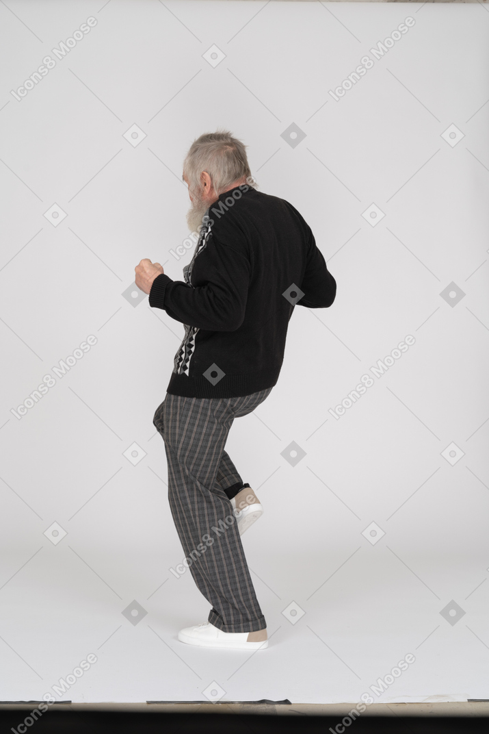 Back view of an old man jogging