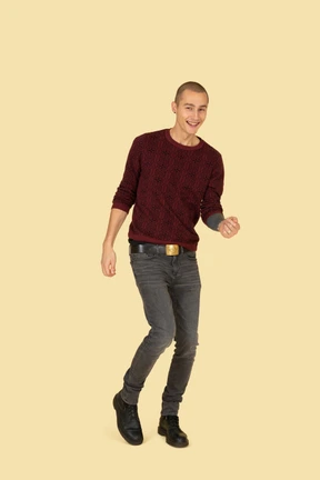 Front view of a dancing young man dressed in red pullover