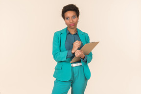 Serious looking female office worker holding folder