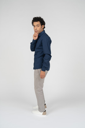 Side view of a man in casual clothes gesturing