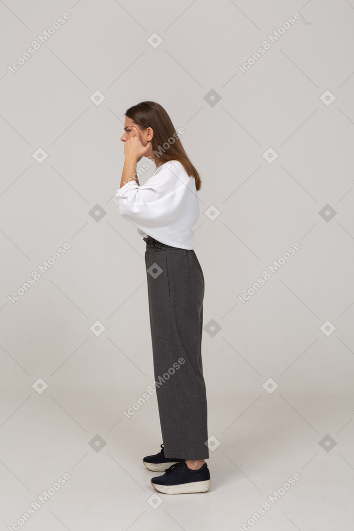 Side view of a young lady in office clothing with bad eyesight