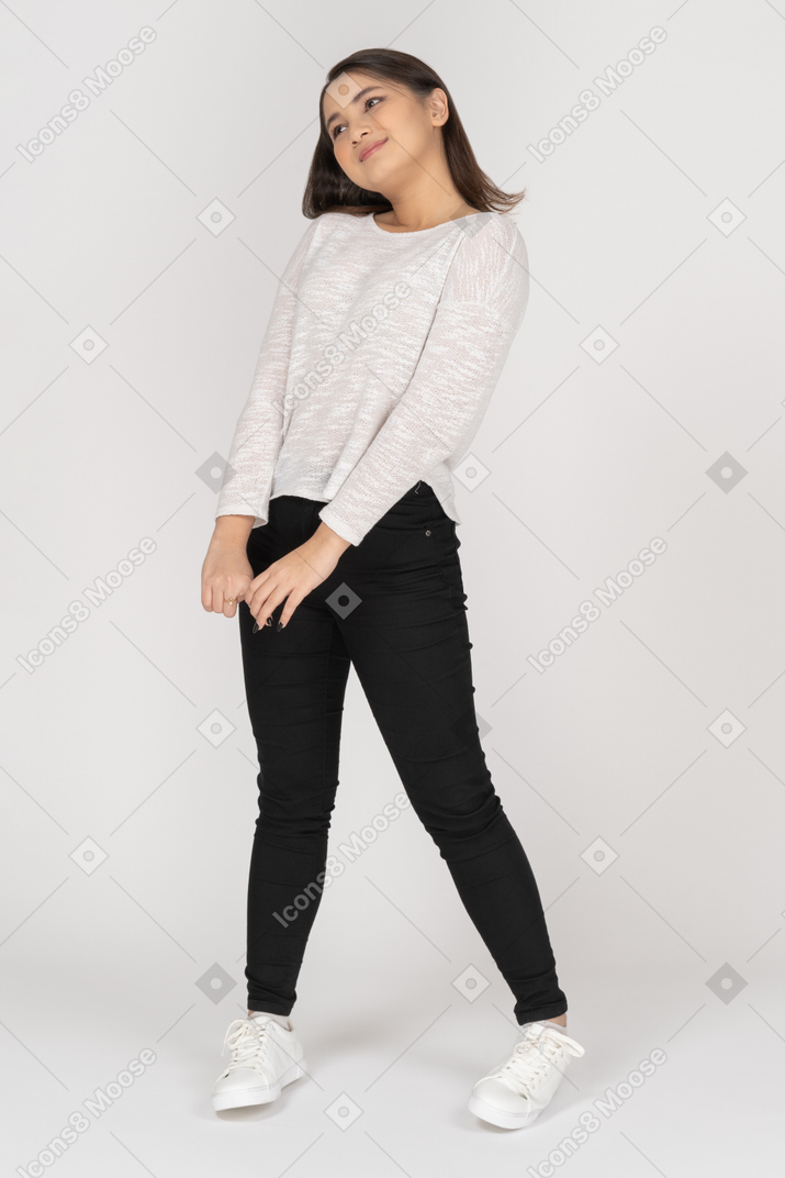 Cheerful girl keeping her feet shoulder width and hands together