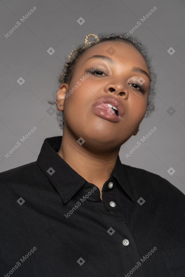 Expressive black woman keeping tongue out