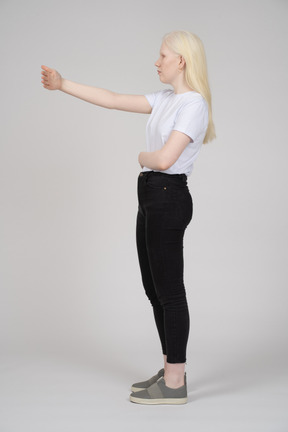 Side view of a long-haired woman raising her arm