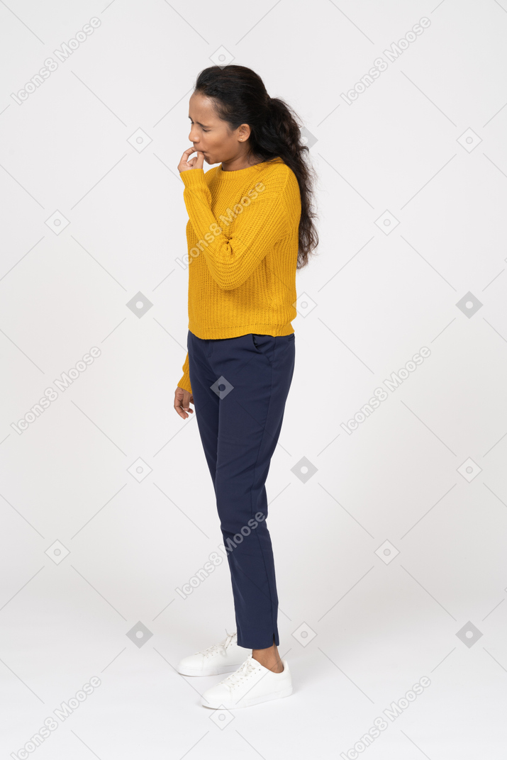 Side view of a girl in casual clothes whistling