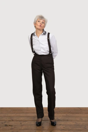 Front view of a pouting old lady in office clothing