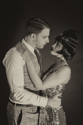 Affectionate old-fashioned couple looking at each other in the dark