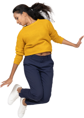Front view of a girl in casual clothes jumping