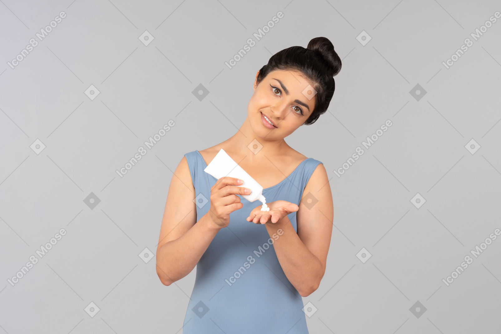 Young indian woman applying hand cream