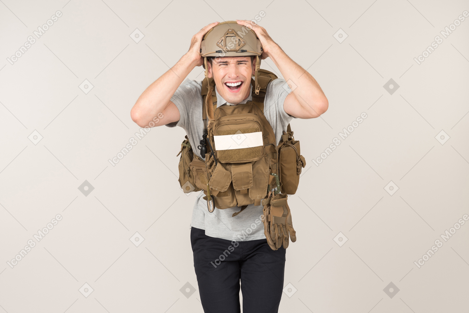 Laughing male journalist in bulletproof vest touching his head