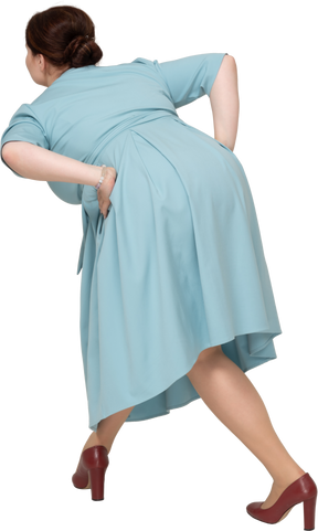 Rear view of a woman in blue dress bending down
