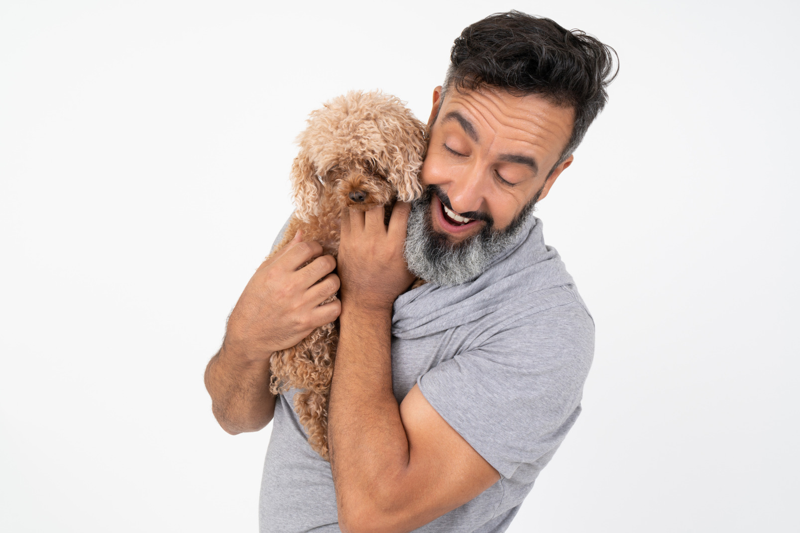Contented mature man holding a puppy