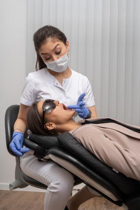 A female dentist examining her female patient