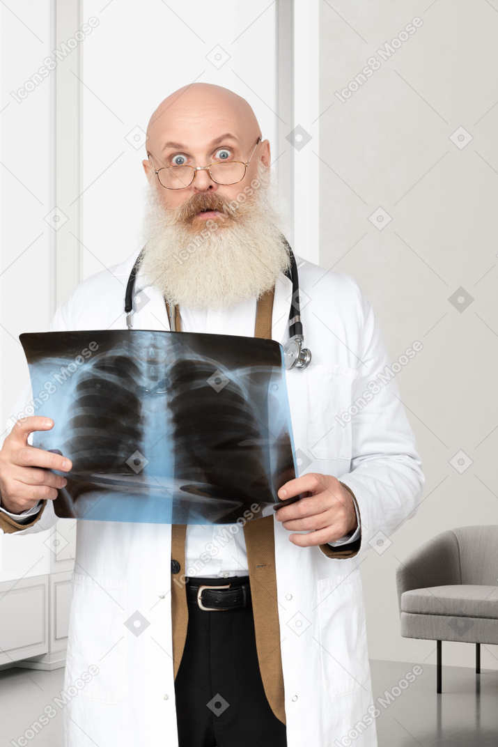 Doctor holding a blank sheet of paper