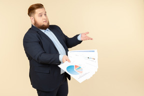 Overweight male office worker showing papers