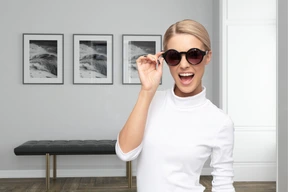 A woman in a white shirt and sunglasses